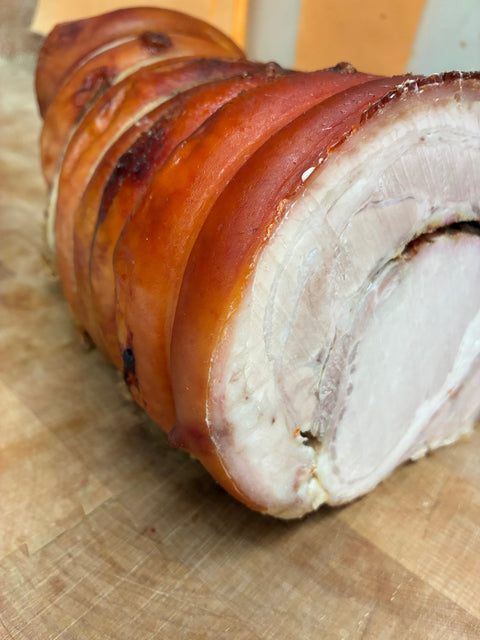 Roasted porchetta, sliced to show the rolled center